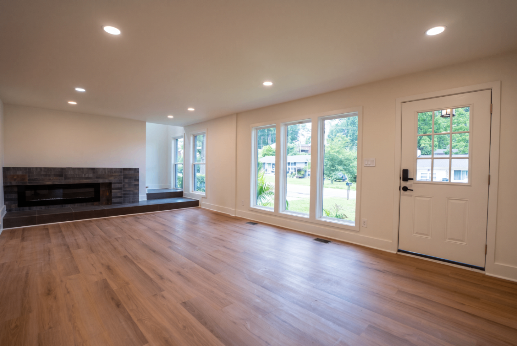 Living room with electric fireplace and luxury tile floors