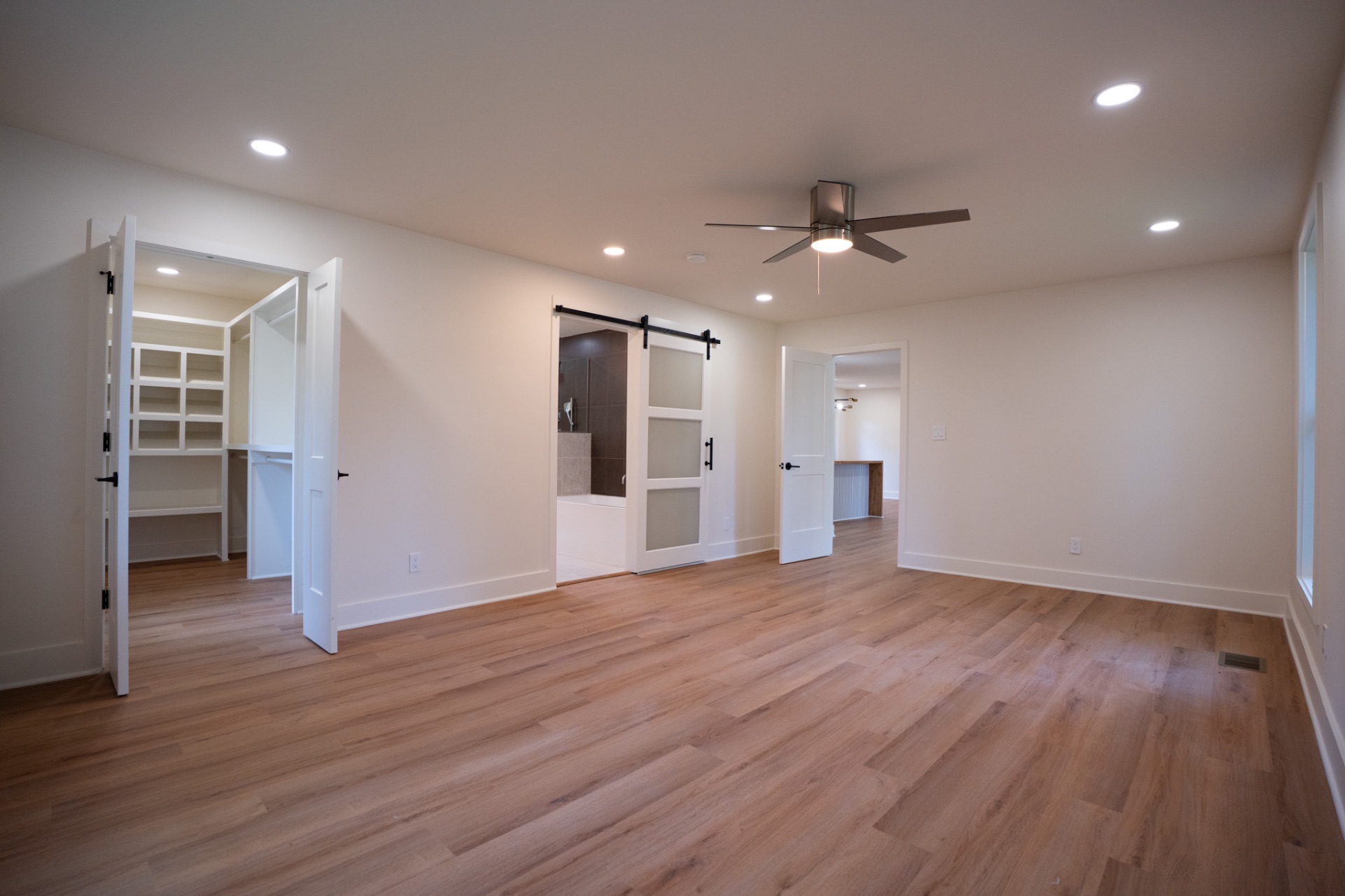 Expansive primary bedroom with walk-in closet and en-suite bath